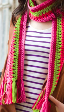 woman modeling a multicolored taffy pull crocheted scarf